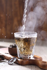 Tea is an aromatic beverage prepared by pouring hot or boiling water over cured or fresh leaves of...
