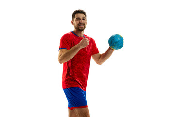 Winner. Portrait of young man, professional handball playing in uniform posing with ball isolated...