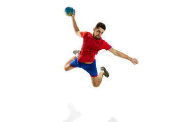 High jump. Man, professional handball player in motion, throwing ball in a jump isolated over white studio background. Concept of sport, action, motion, championship, sportive lifestyle