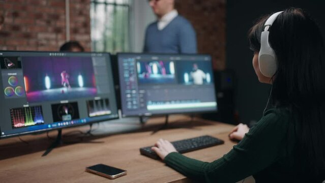 professional editor and colourist woman making color grading of musical video, work in creative studio