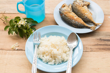 rice, fried mackerel fish healthy foods arrangement flat lay style on background wooden