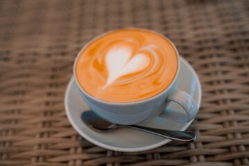A cup of cappuccino is on the table. Coffee with espresso and milk in a cafe