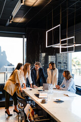 Group of businesspeople discussing project during meeting at office