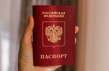 Person holds Russian travel passport in hand. Travel, tourism or immigration concept. Russian citizenship. High quality photo. 