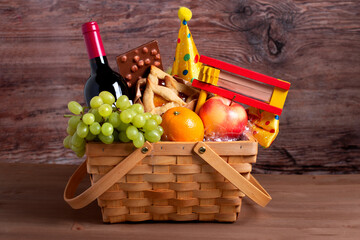 Purim gift basket with foods, wine, gragger and carnival costume accessories