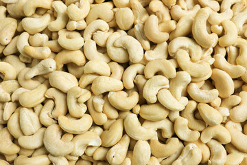 Raw cashew nuts as a background, top view.