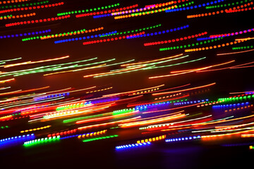 Blurred abstract background. Drawing with light, garlands.