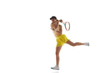 One young teen girl, tennis player in sports uniform playing tennis isolated over white background. Concept of sport, fashion, motivation, education and achievement