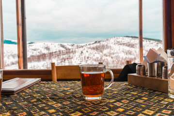 Hot boiled brandy on a table with mountain background - 568738678