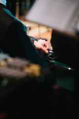 Member of a musical band waits to play his instrument before a concert in the theatre