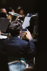 Trumpet player from behind during a band concert in the theatre