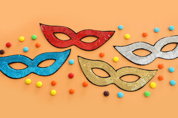 Holidays image of mardi gras masquarade sequins masks over yellow background. view from above
