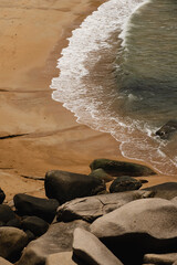 rocks on a beach with Christal clear water and sky