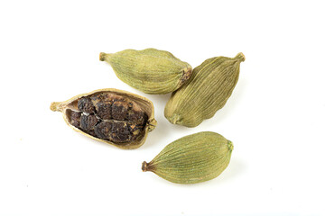 Pods with green cardamom seeds on a white background.