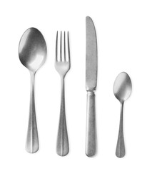 New shiny cutlery set on white background, top view