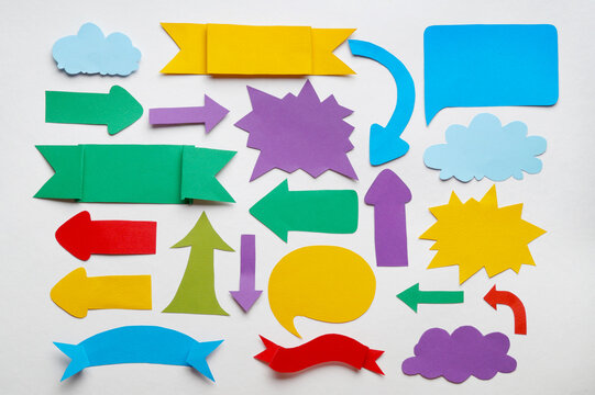 Different speech bubbles and arrows on white background, flat lay. Space for text - Powered by Adobe