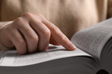 Woman reading new holy Bible, closeup view