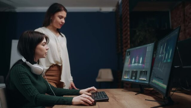 video editor and director women discussing final cut of movie or musical clip in studio, teamwork