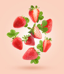 Delicious sweet strawberries and green leaves flying on pale pink background