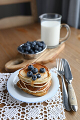 delicious homemade pancakes with blueberries on wooden background