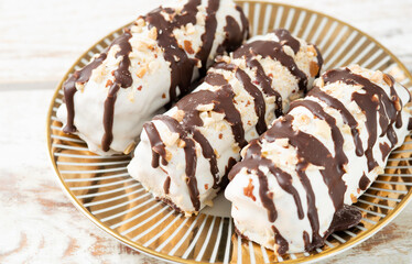 butter cookies dessert covered in chocolate and walnut glaze on gray table