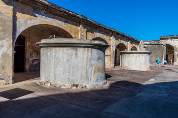 A view down the courtyard past water cisterns in of the Castle of San Cristobal, San Juan, Puerto...