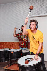Man drumming with maces inside a studio