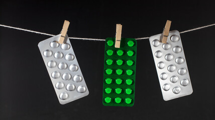 Clothesline with hanging medication blisters.