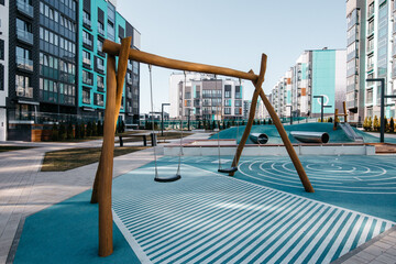Eco-friendly modern colorful wooden children kids playground yard with beautiful lawn in a new...