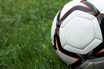 Fototapeta na wymiar New soccer ball on fresh green grass outdoors, closeup
