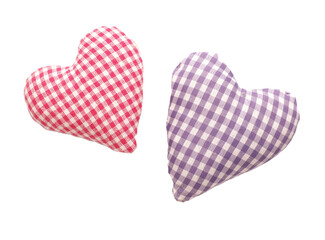 Close up of two checkered fabric heart shapes