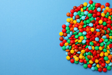 Tasty colorful candies on blue background, flat lay. Space for text