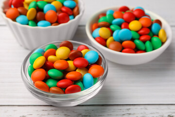 Tasty colorful candies on white wooden table, closeup