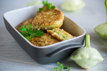 vegetable fried squash and zucchini cutlets in a ceramic form