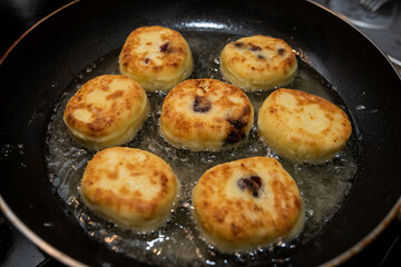 fresh tasty cheese pancakes cheesecakes are fried in a pan, ukraine traditional food