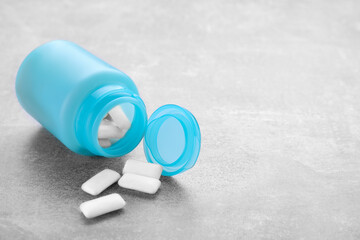 Jar with chewing gums on light table. Space for text