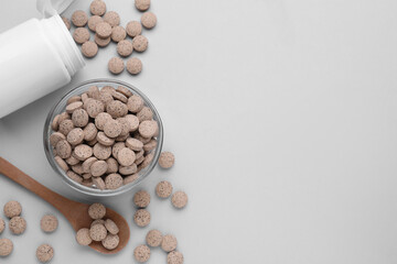 Flat lay composition with brewer`s yeast tablets on light grey background. Space for text
