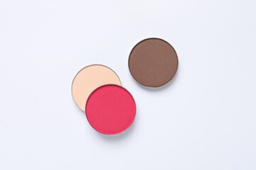 Different beautiful eye shadows on white background, flat lay