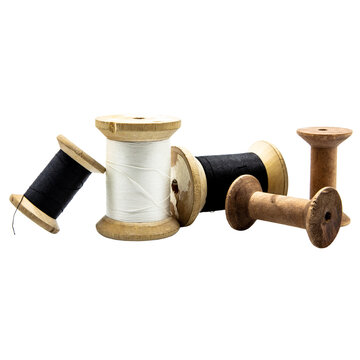 many thread sewing spools with black or white thread, some are empty