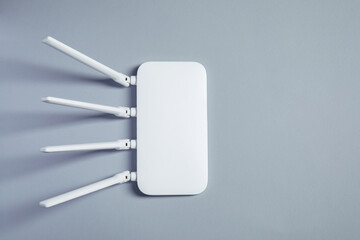 New stylish Wi-Fi router on grey background, top view. Space for text