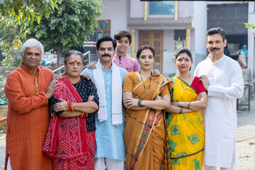 Portrait of happy multi-generation family standing at outside the home.