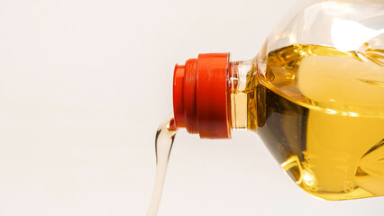 A bottle of sunflower oil isoalted on a white background.