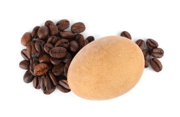 Easter egg painted with natural dye and coffee beans on white background, top view