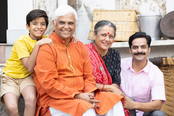 Happy Indian rural family setting at home.