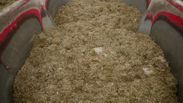 farm equipment, modern technologies for grinding and preparation of combined feed from silage hay and cereals for feeding dairy cows on a livestock farm, top view