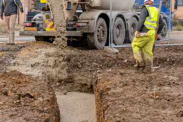 Ready-mix semi-dry concrete delivered on construction site and discharged from the mixing truck