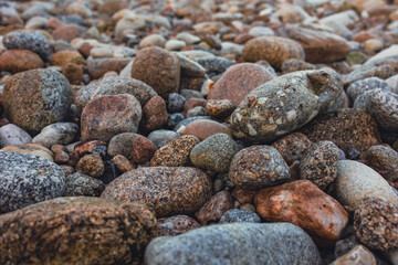 Beautiful, smooth stones of different sizes on the ocean shore