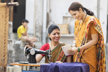 Indian woman using sewing machine at home.