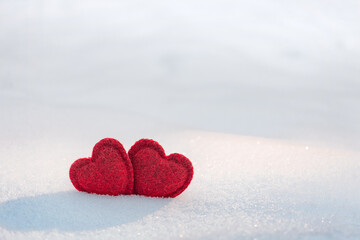 Fototapeta premium two hearts together on a white snow. In love, Valentine's Day, February 14 postcard