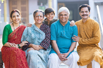 Portrait of happy multi-generation family standing at outside the home.